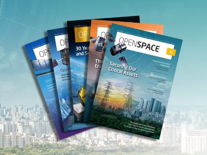 Covers of OpenSpace magazine on a background showing city skyline